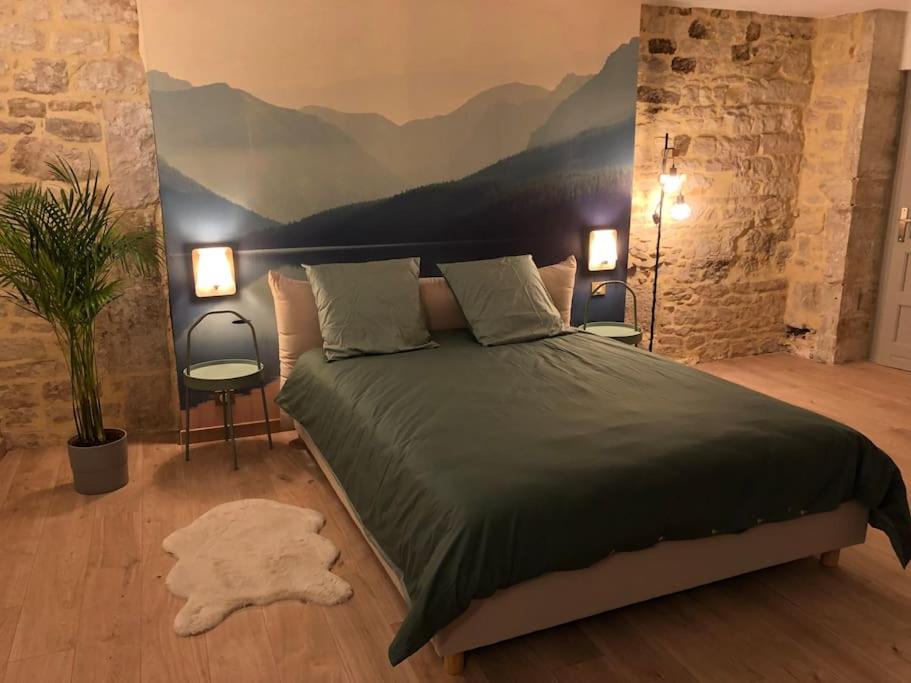 a bedroom with a bed with a mountain mural on the wall at Nuits centre : superbe gîte rénové et climatisé in Nuits-Saint-Georges