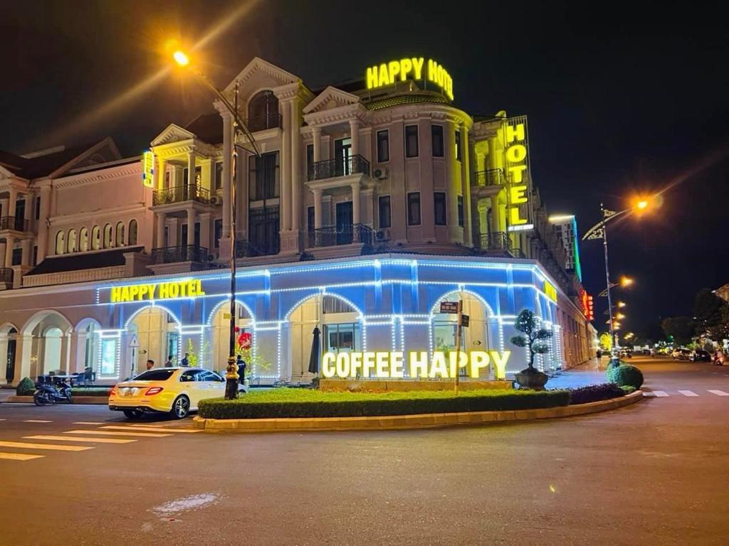 a building with a coffee happy sign in front of it at HAPPY HOTEL Kien Giang in Ấp Rạch Mẹo