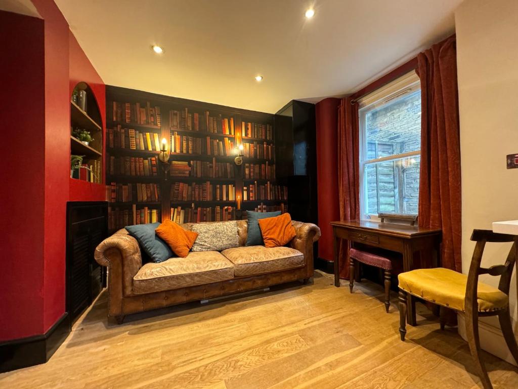 a living room with a couch and a table at Absolute Clapham in London