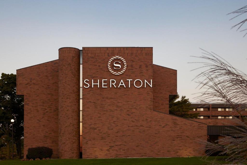 a building with a sign on the side of it at Sheraton Grand Rapids Airport Hotel in Grand Rapids