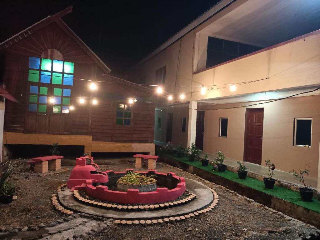 a courtyard of a house at night at Lawer Guesthouse (Pulau Langkawi) in Pantai Cenang