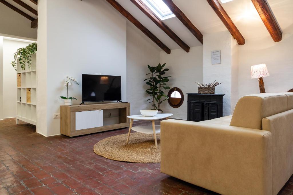 a living room with a couch and a tv at Matteotti Gallery Venice Apt in Mestre