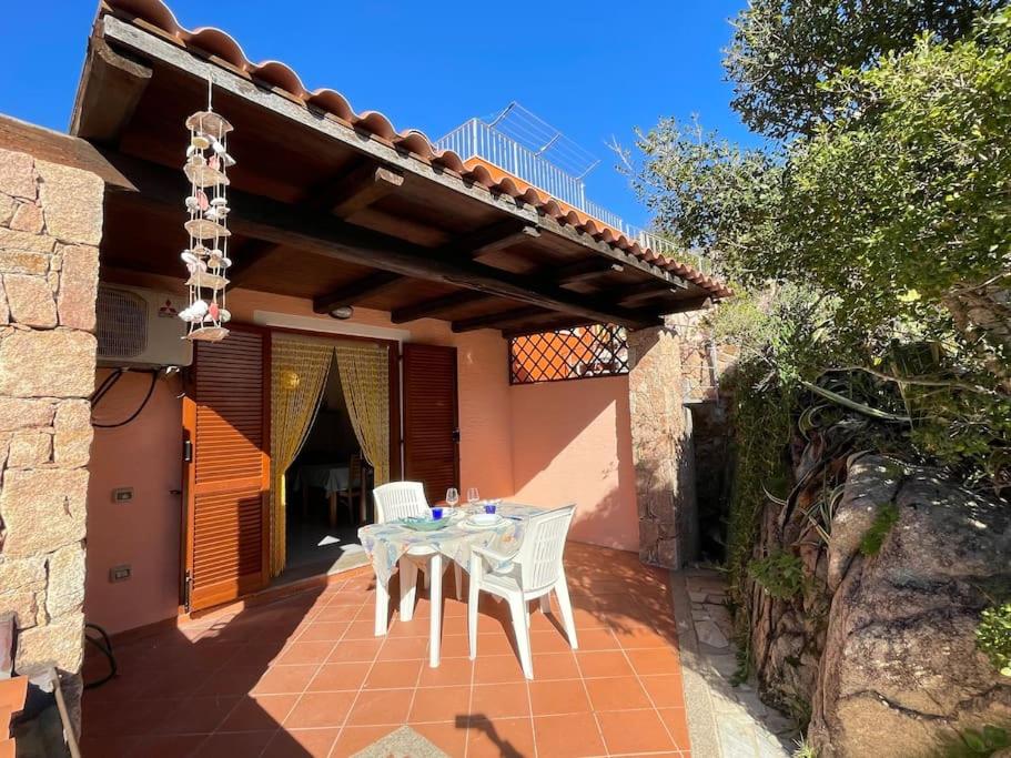 a patio with a table and chairs on a house at Blue Sardinia house in Rena Majore