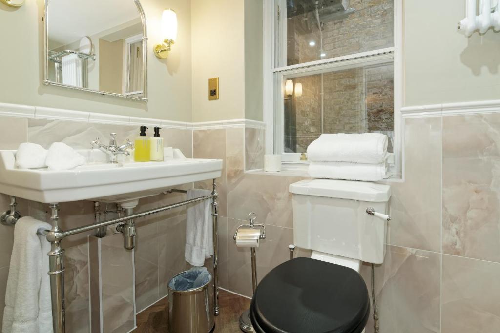 a bathroom with a toilet and a sink at Old Town House by Ezestays in Margate