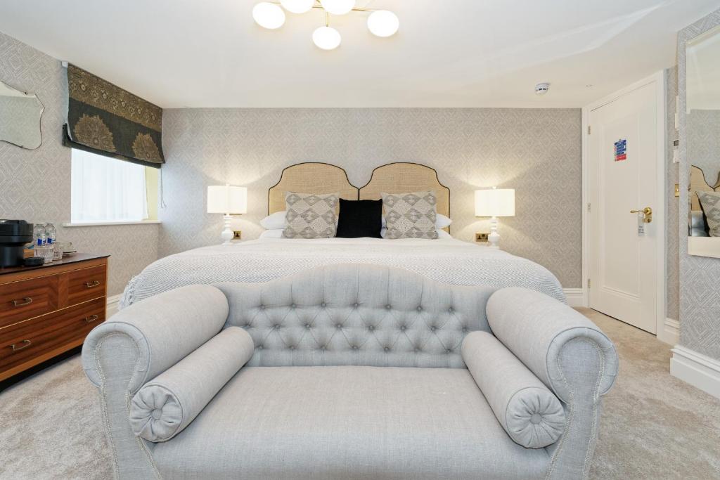 a large bedroom with a white bed and a couch at Old Town House by Ezestays in Margate