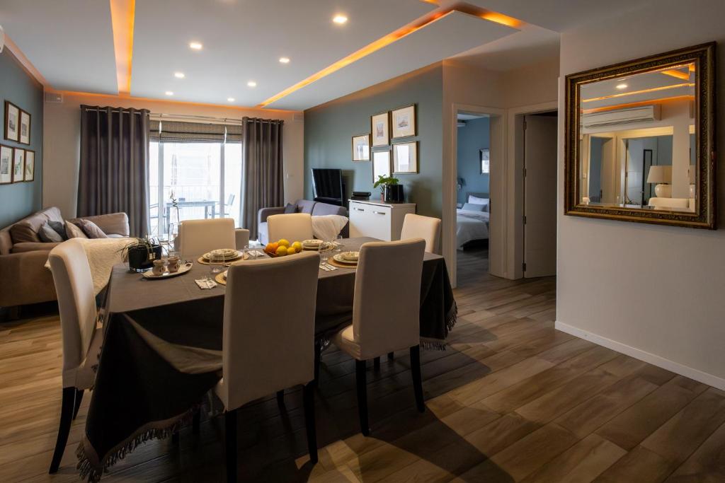 a dining room and living room with a table and chairs at Four Seasons Apartment 9 in St. Paul's Bay