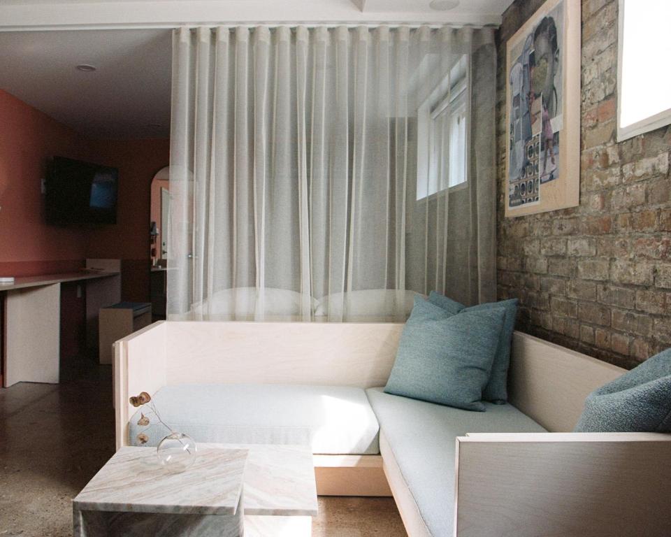 a living room with a white couch with blue pillows at Ode in Toronto