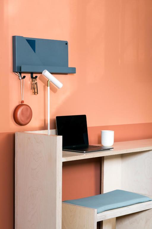 a desk with a laptop and a lamp on it at Ode in Toronto