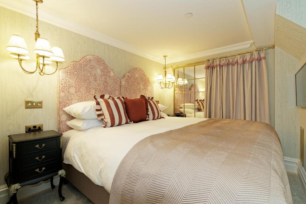 a bedroom with a large bed and a mirror at Old Town House by Ezestays in Margate