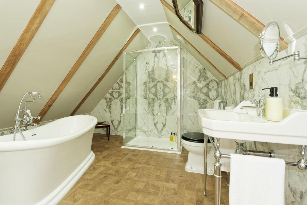 a bathroom with a tub and a sink and a shower at Old Town House by Ezestays in Margate