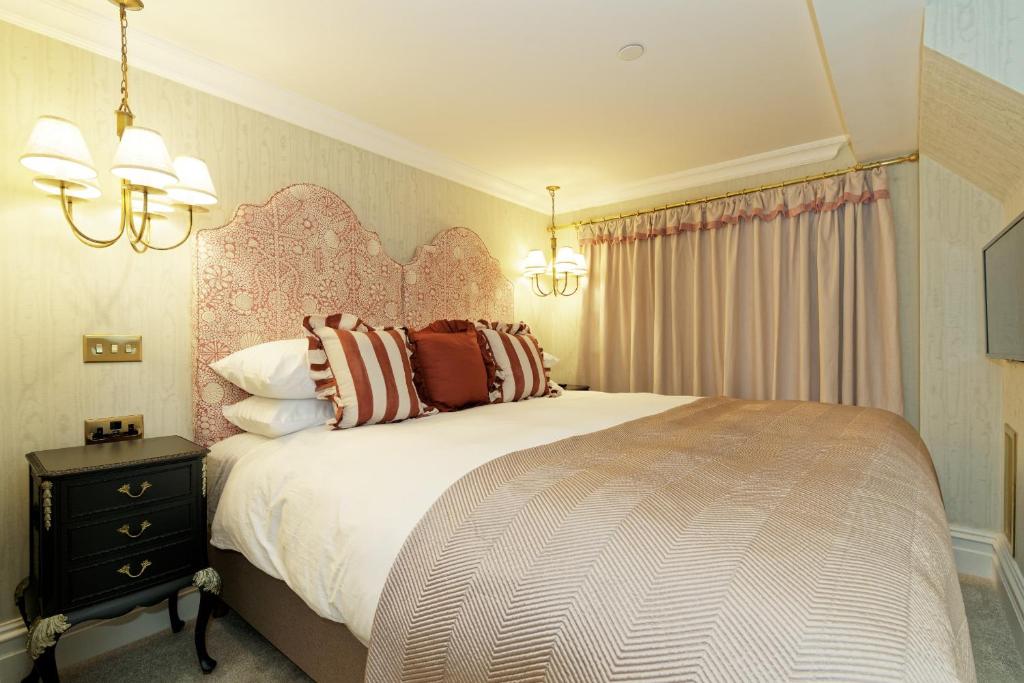 a bedroom with a large bed with pillows on it at Old Town House by Ezestays, IN THE HEART OF THE OLD TOWN MARGATE in Margate