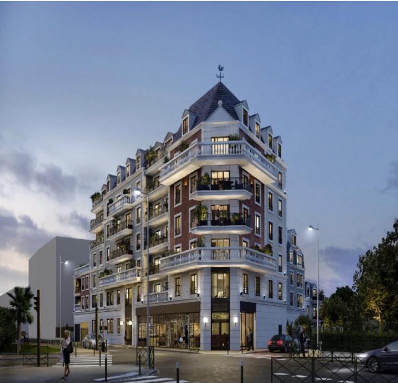 a tall building with a lot of windows at Appt spacieux et calme prox Disney-CDG-Stade de France in Le Blanc-Mesnil