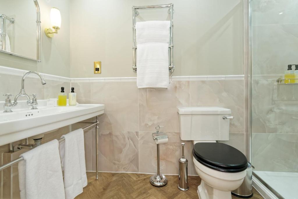 a bathroom with a toilet and a sink at Old Town House by Ezestays in Margate
