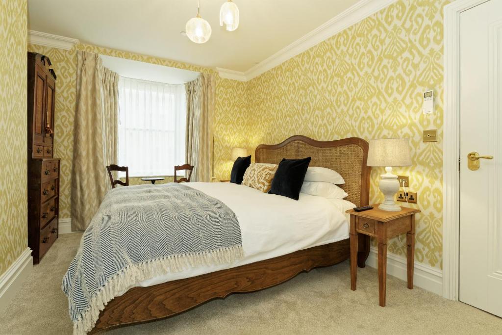 a bedroom with a large bed and a window at Old Town House by Ezestays in Margate