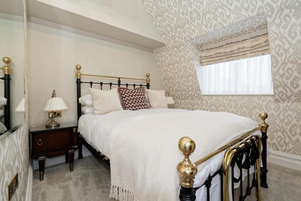 a bedroom with a large bed and a window at Old Town House by Ezestays in Margate