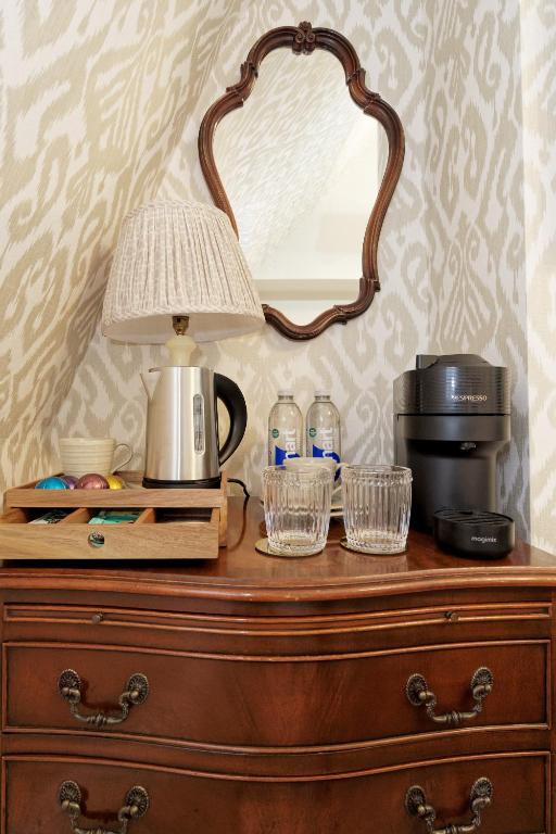 a mirror on top of a dresser with a coffee maker at Old Town House by Ezestays in Margate