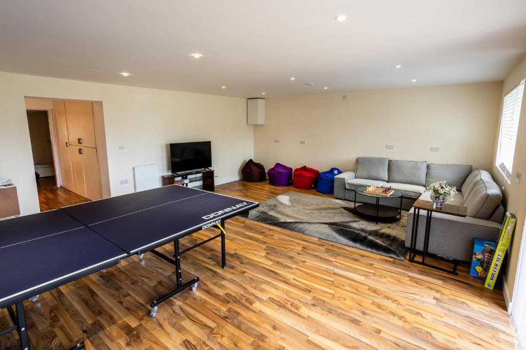 un soggiorno con tavolo da ping pong. di Fernbanks a Ferndown