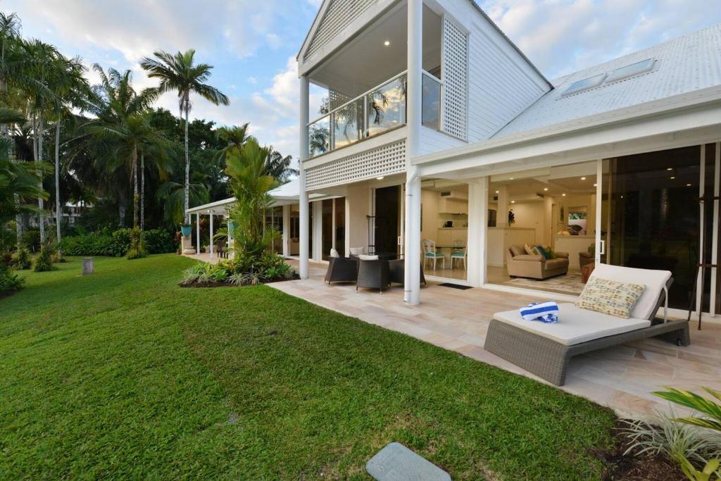 an exterior view of a house with a lawn at Fairway Vistas - A Group Escape at Mirage Resort in Port Douglas