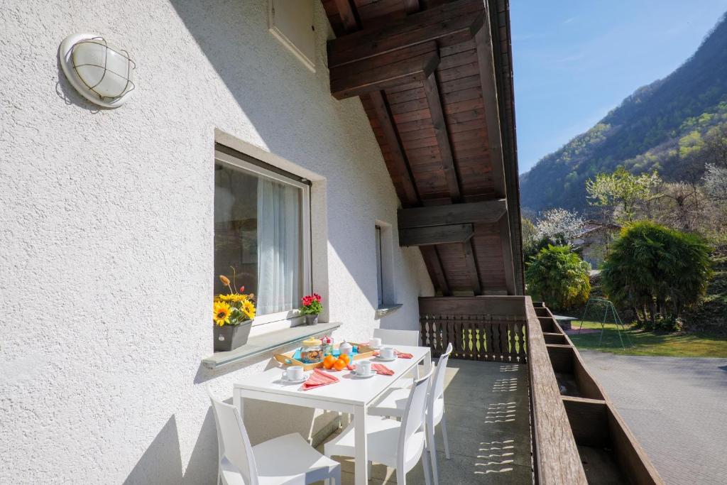 a white table and chairs on a balcony at Casa Carlo in Colico