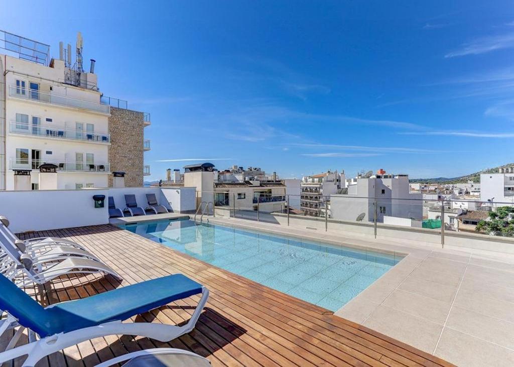 a balcony with a swimming pool on top of a building at Apt Ca na Claire in Port de Pollensa