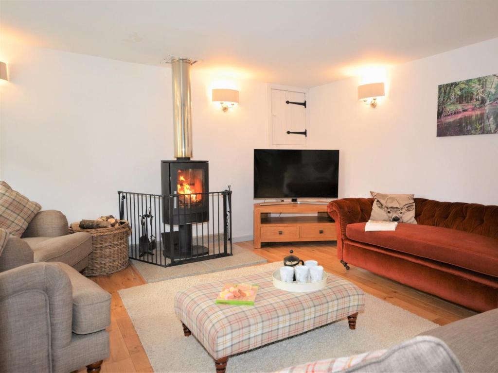 a living room with a couch and a fire place at 3 Bed in Winkleigh 66043 in Winkleigh