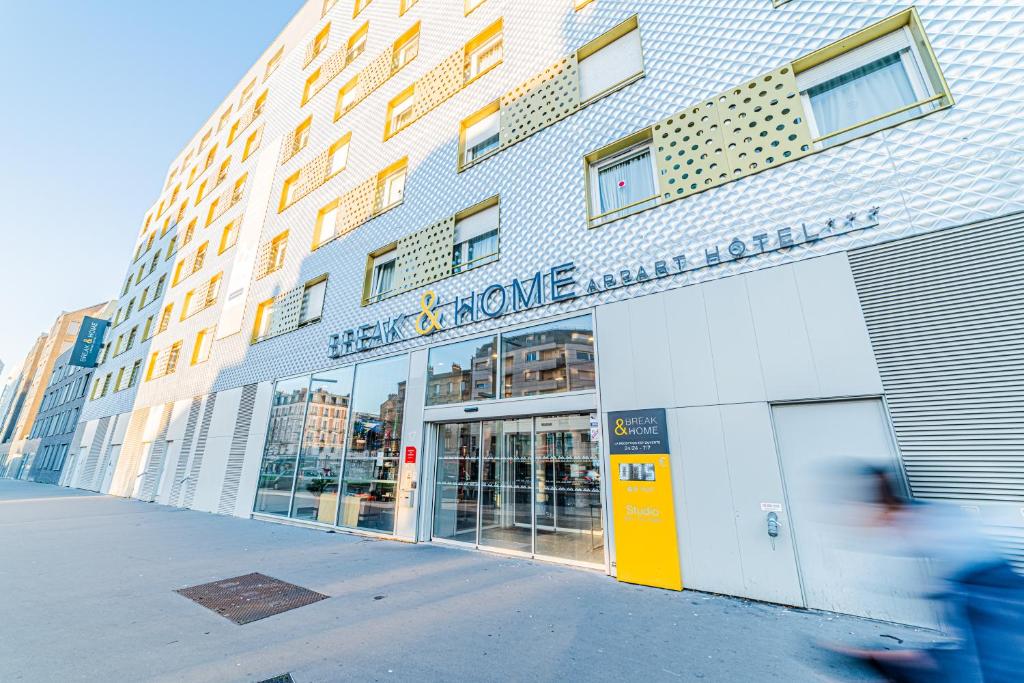 a building with a sign on the front of it at Break & Home Paris Italie Porte de Choisy in Ivry-sur-Seine