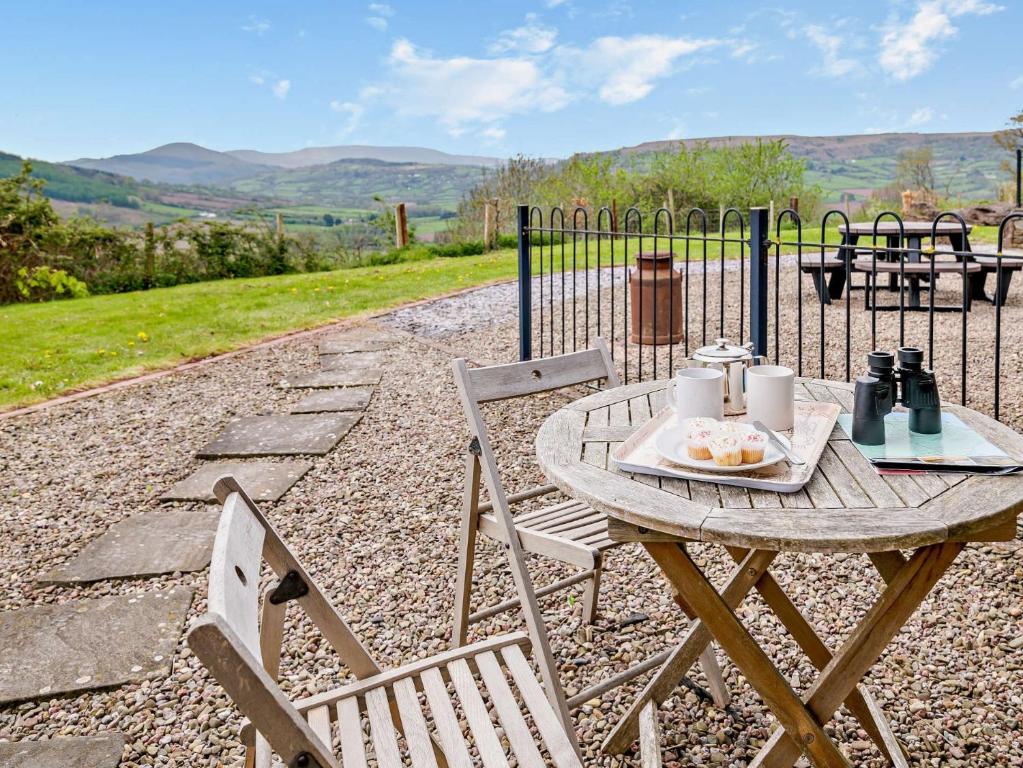 a wooden table with a plate of food on it at 1 bed property in Tretower Brecon Beacons BN126 