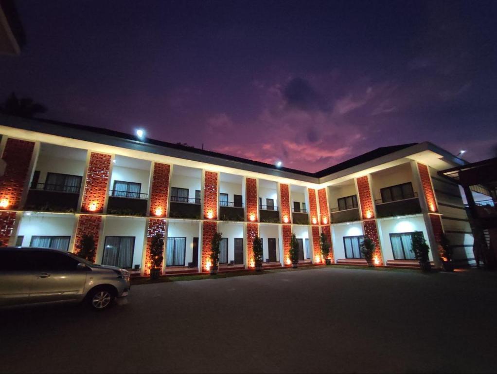 a building with a car parked in front of it at Nirvana House (Guest House Syari'ah) in Salatiga