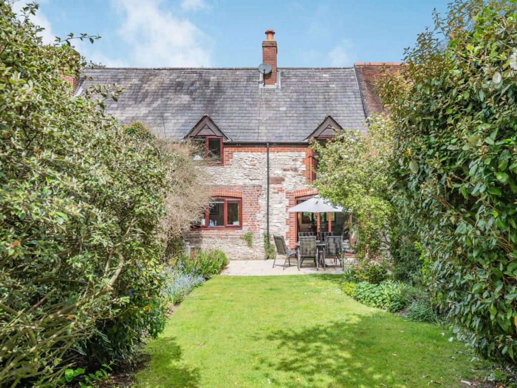 an external view of a brick house with a garden at 3 Bed in Winfrith Newburgh DC108 in Winfrith Newburgh