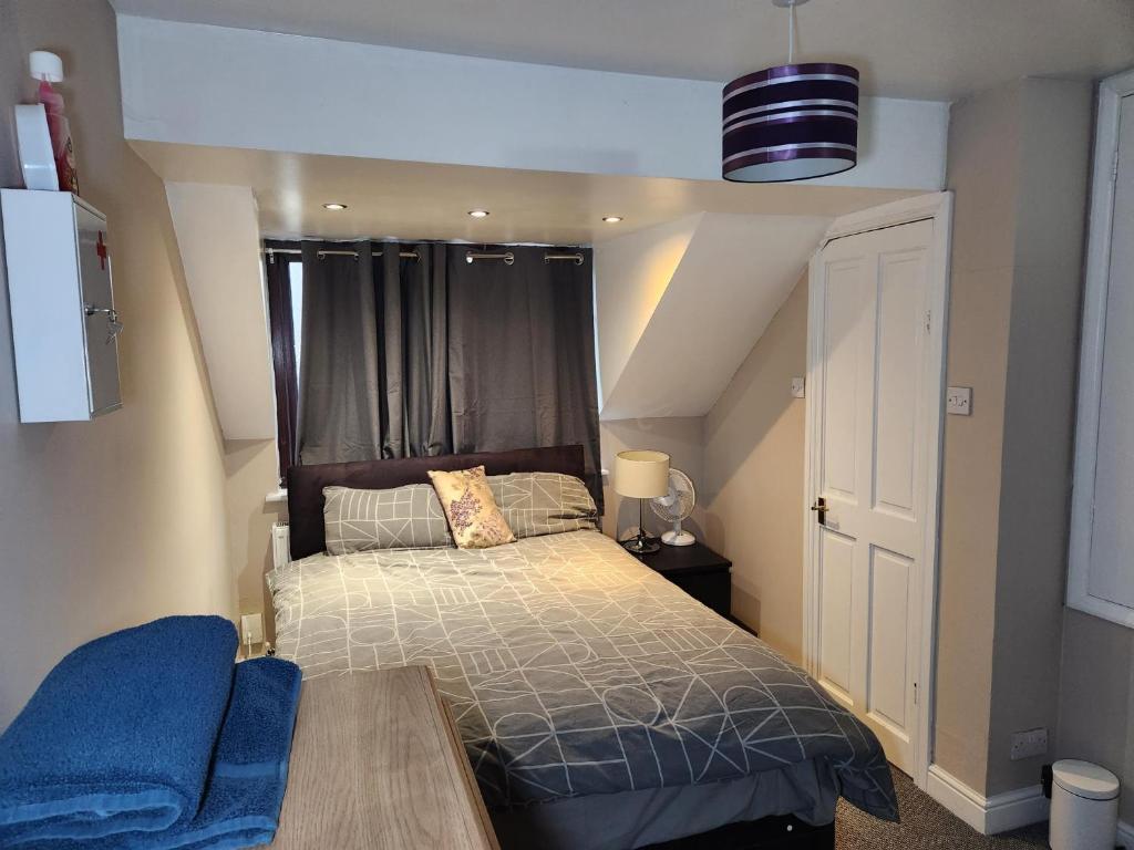 a small bedroom with a bed and a table at Tuscawilla 2 in Plumstead