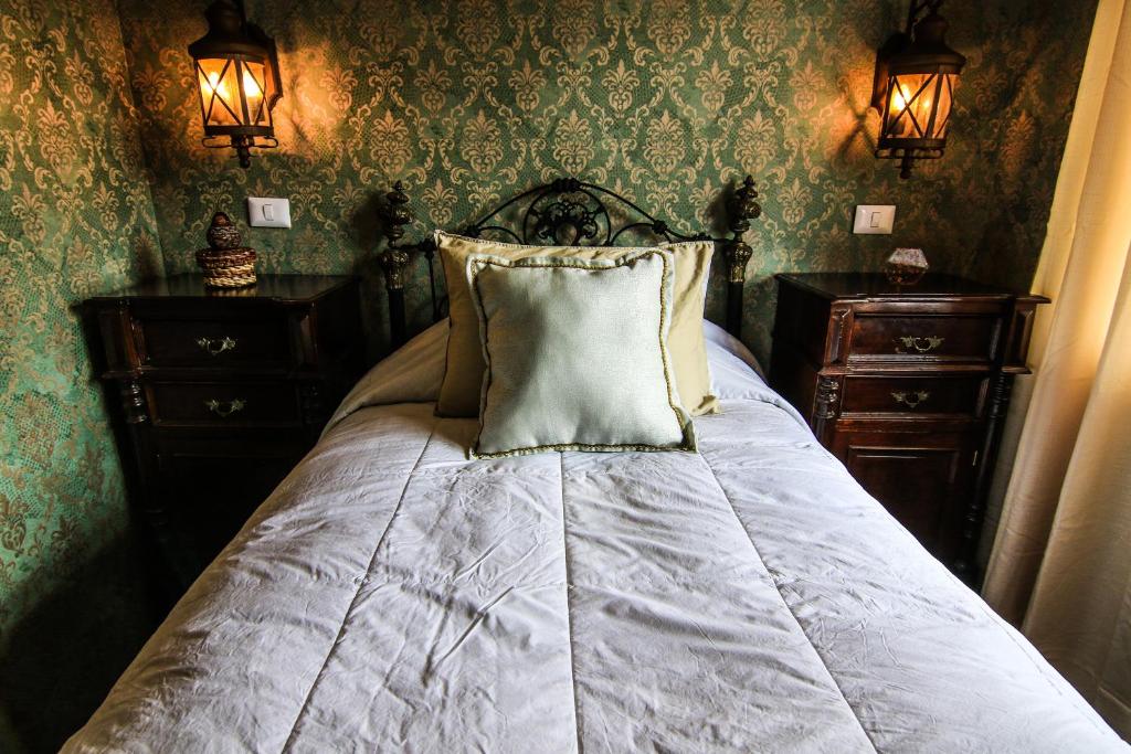 a bedroom with a bed with a pillow and two dressers at Bamba House Cusco in Cusco
