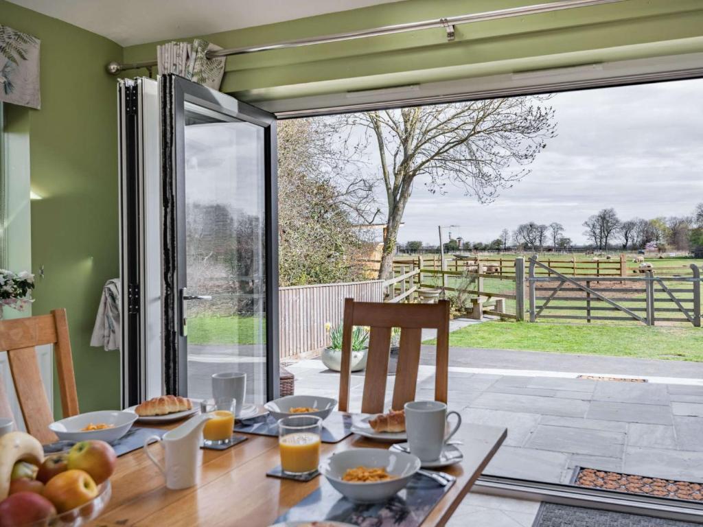 a table with food and a view of a field at 4 Bed in Manby 87031 in Manby
