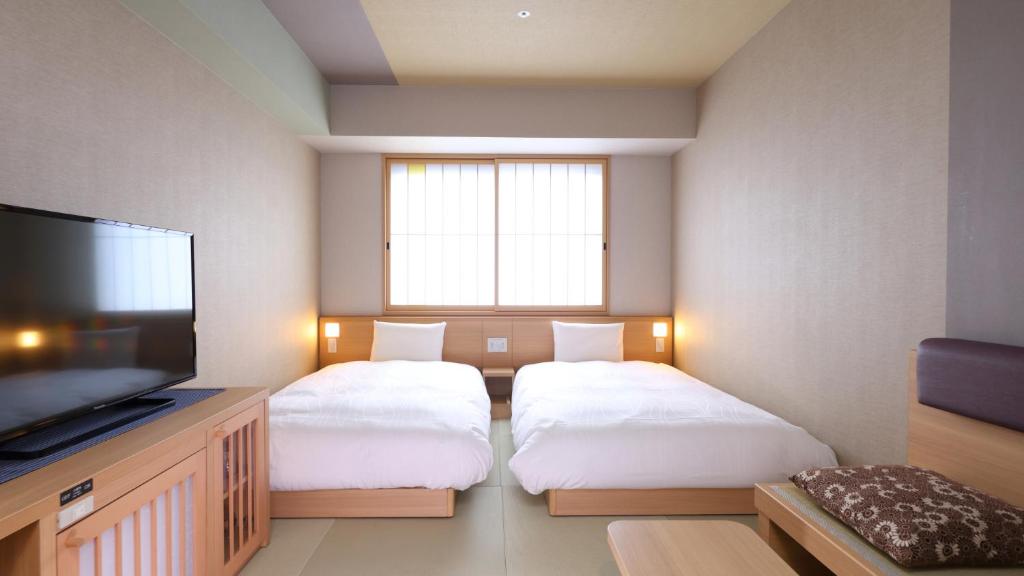 Postel nebo postele na pokoji v ubytování Onyado Nono Asakusa Bettei Hot Spring