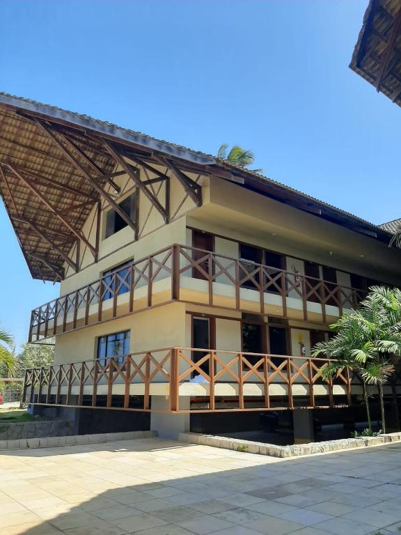 a building with a balcony in front of it at Eco Paradise ap 122 in Cumbuco