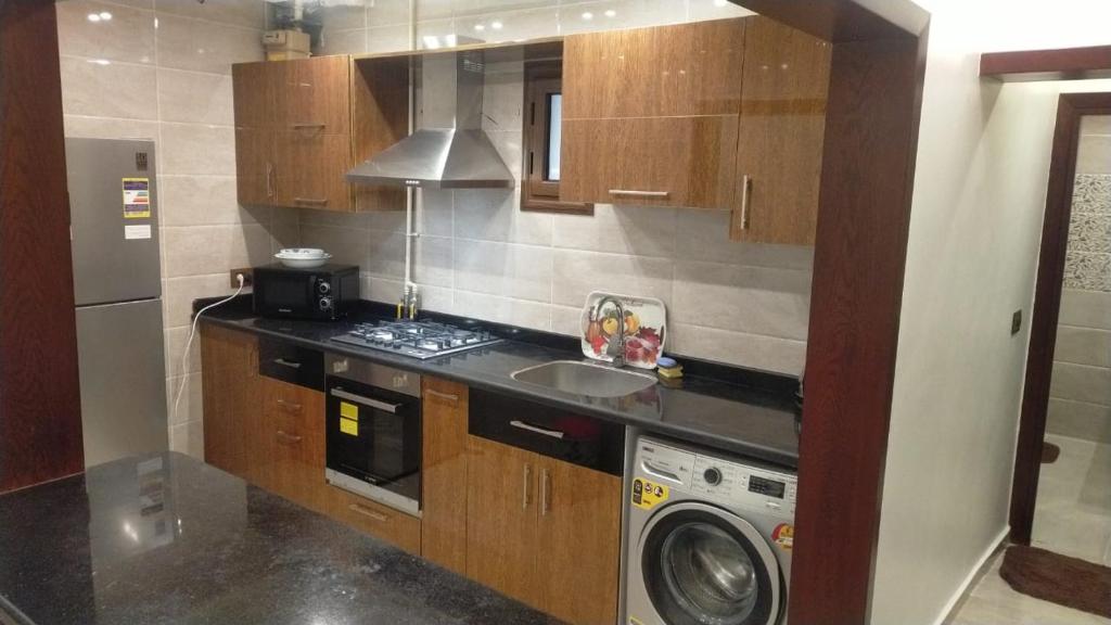 a kitchen with a sink and a washing machine at Tolip appartement sea view in Alexandria