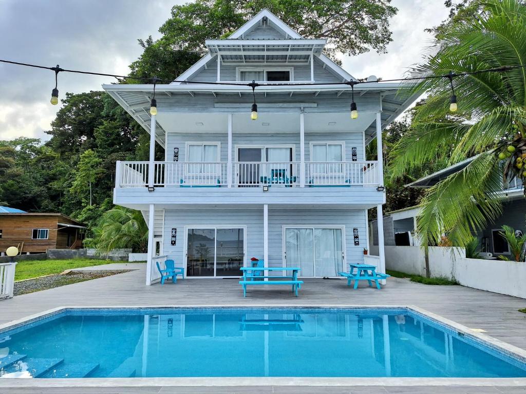 a house with a pool in front of it at Paunch Beach Retreat in Bocas Town