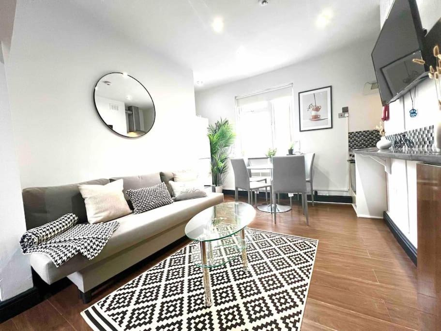 a living room with a couch and a table at 2 Bed- Camden Town in London