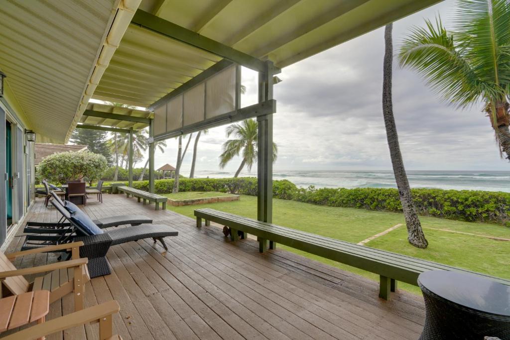 a porch with benches and a view of the ocean at Waianae Beach House with Direct Coast Access and Views in Waianae