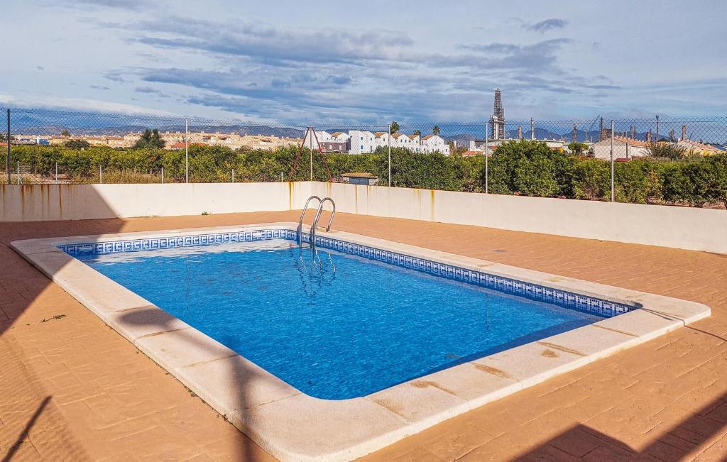 a swimming pool on the roof of a house at Amazing Home In Playa De Almazora With Kitchen in San Antonio