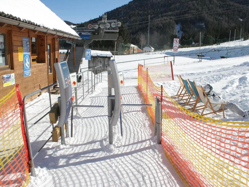 a fence at a ski slope with snow on it at Exclusive chalet in Hohentauern in ski area in Hohentauern