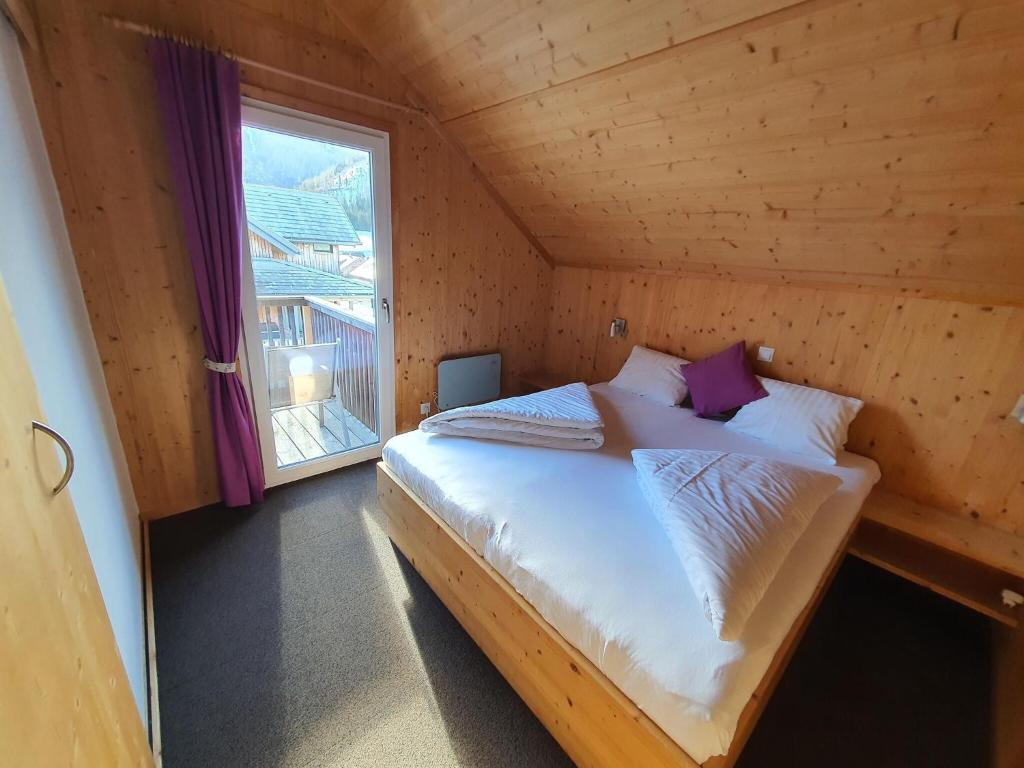 a bed in a small room with a window at Exclusive chalet in Hohentauern in ski area in Hohentauern