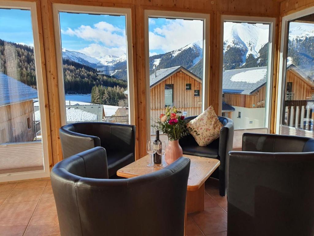 a room with a table and chairs and windows at Exclusive chalet in Hohentauern in ski area in Hohentauern