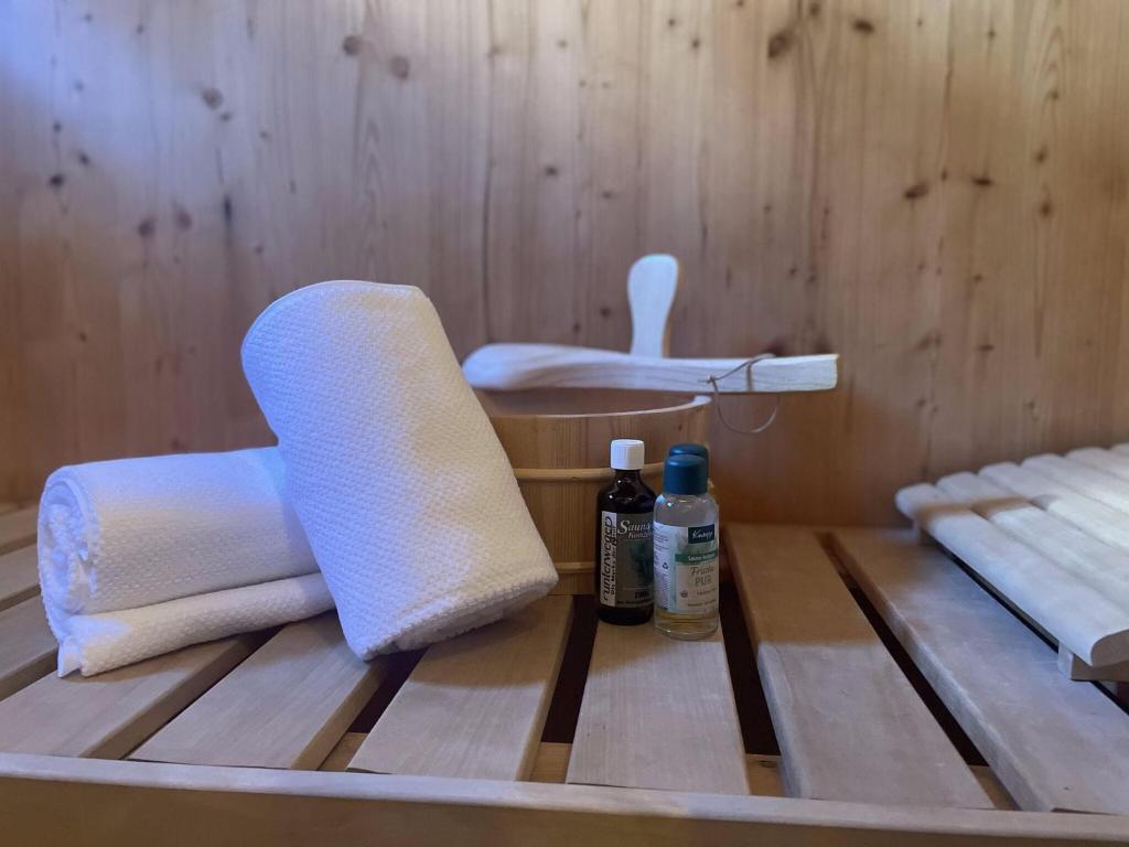 a sauna with towels and bottles on a wooden table at Exclusive chalet in Hohentauern in ski area in Hohentauern