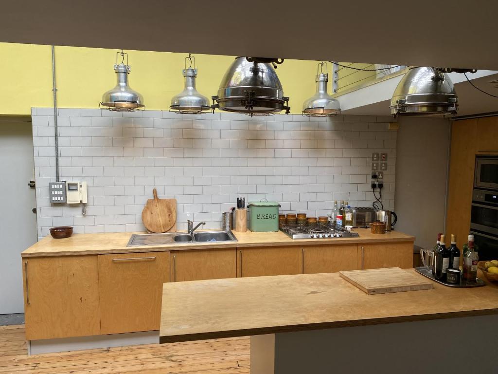 a kitchen with a sink and some pots and pans at Victoria Park Apartment in London