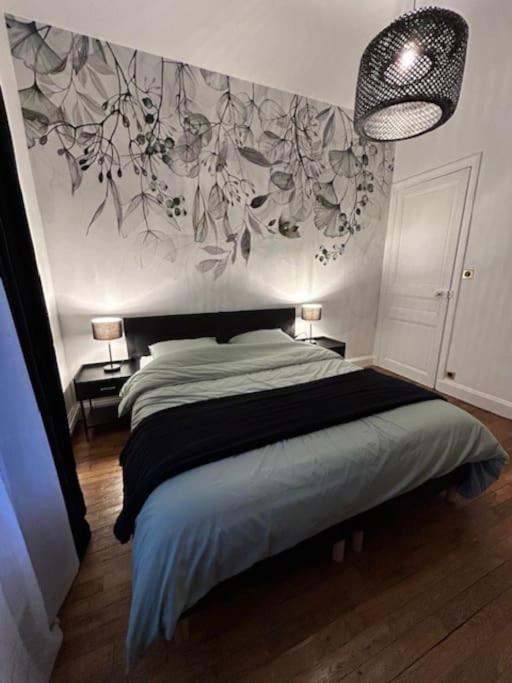 une chambre avec un lit avec un tableau sur le mur dans l'établissement Le Blandan 171. Appartement F2 quartier Nancy-Thermal, à Nancy