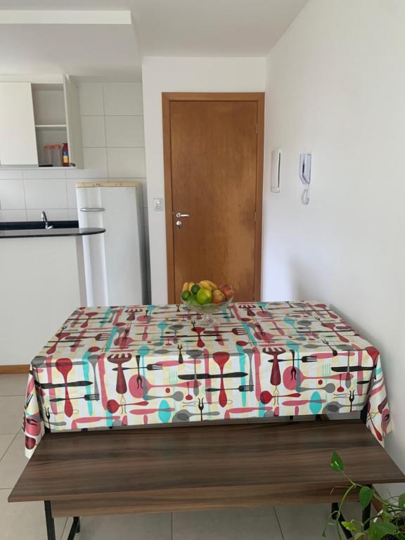 a bed in a room with a bowl of fruit on it at JacaraipeTop in Serra