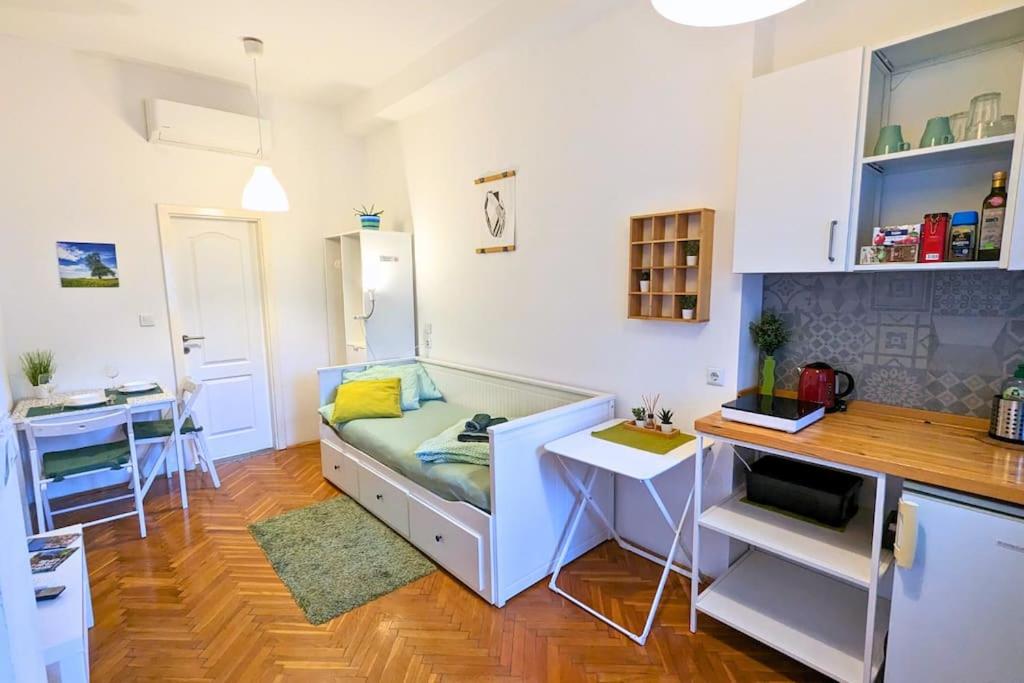 a small living room with a couch and a desk at Cozy ensuite room in Zagreb center in Zagreb