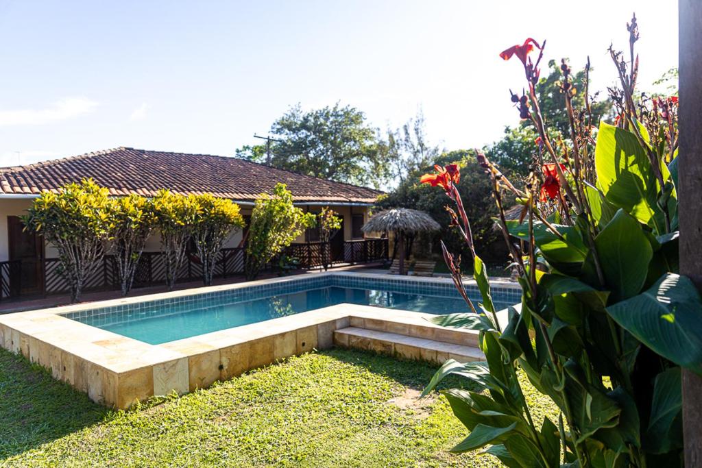 a swimming pool in the yard of a house at Pousada O Canto do Francês in Soure