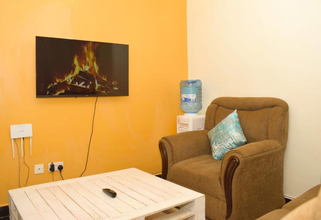 a living room with a chair and a fireplace at Fully furnished One bedroom bnb in Thika Town. in Thika