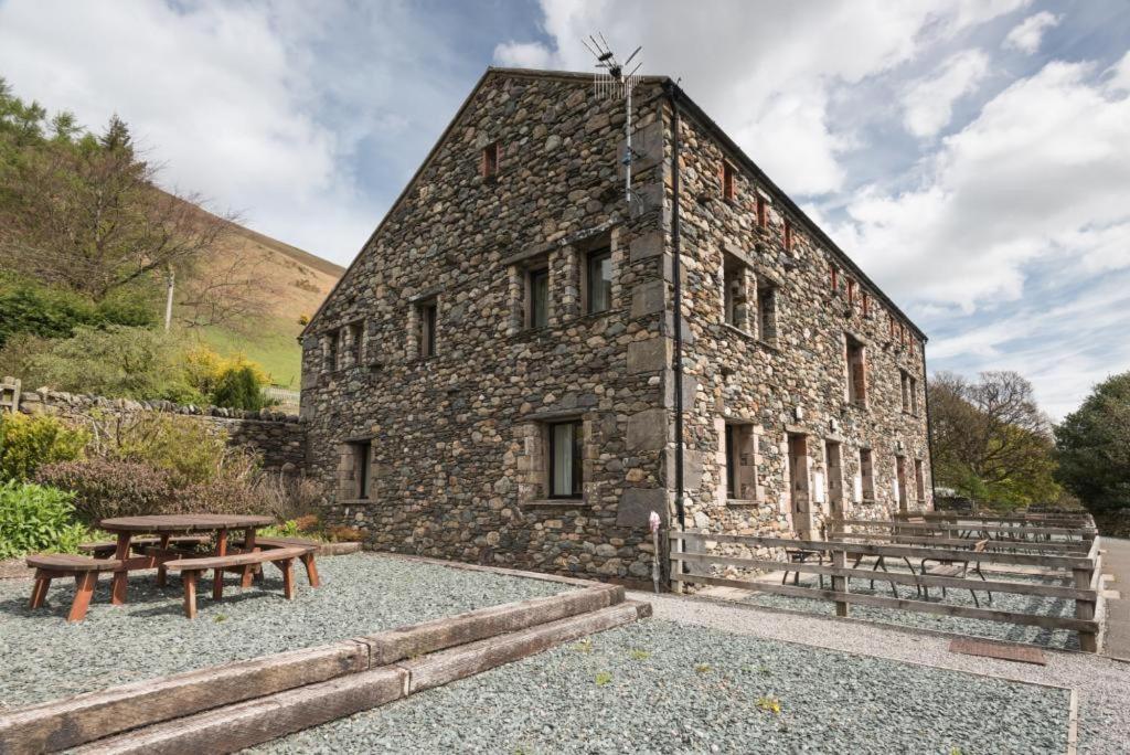 a stone building with a picnic table and benches at 3 Bed in Threlkeld SZ433 in Threlkeld